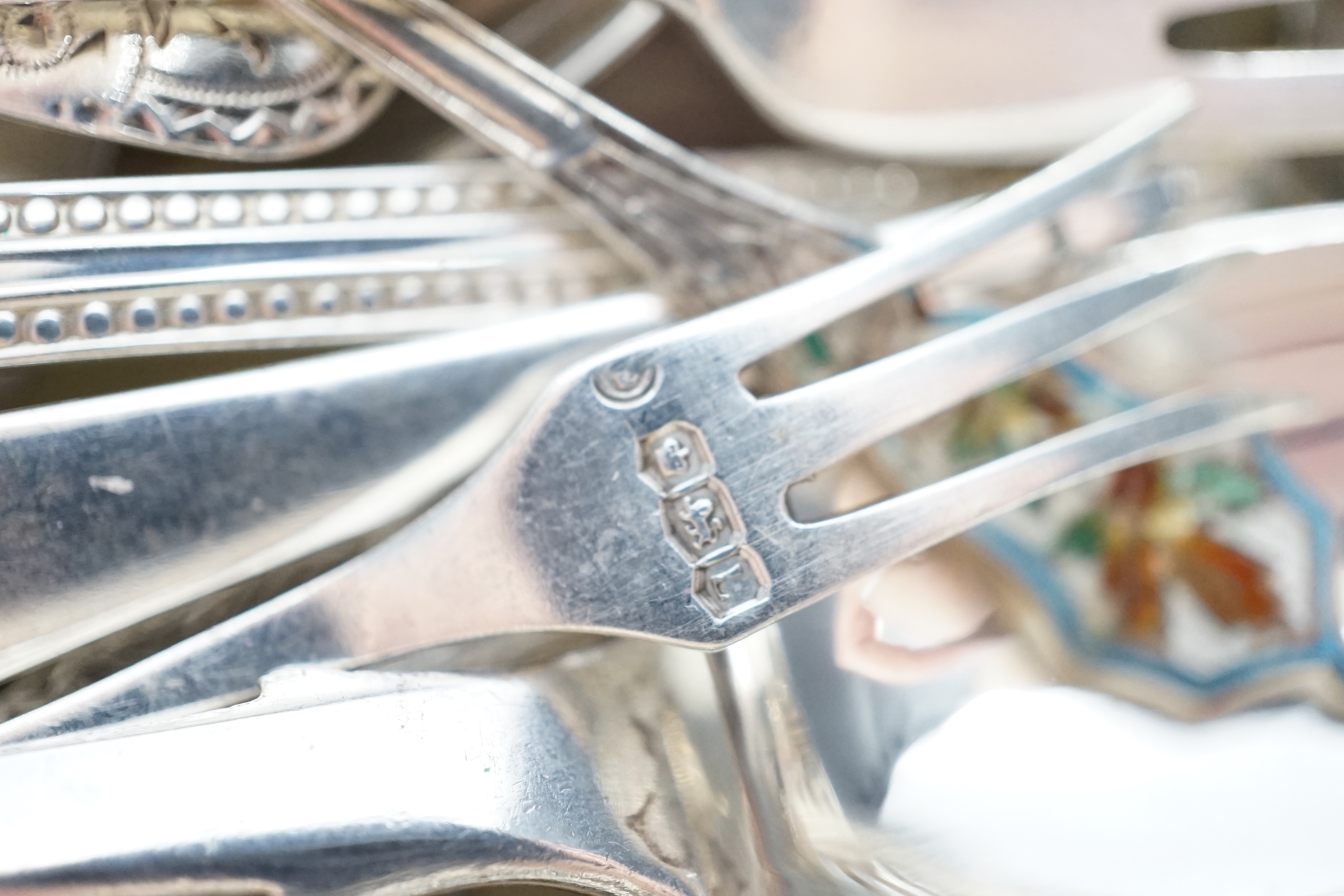 Sundry silver cutlery, including a butter knife, teaspoons, condiment spoons, sauce ladles, etc.